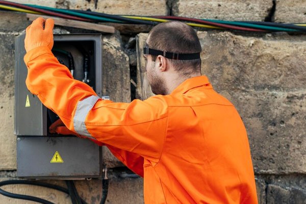 Level 2 electrician inspecting an electrical service cabinet